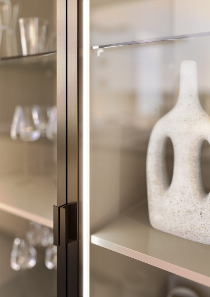 Glass cabinet with a bronze frame and handle